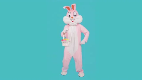 Easter bunny or rabbit or hare cute kid boy or girl holds basket of colored eggs Video stock 149616861