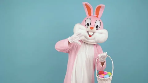 Easter bunny or rabbit or hare cute kid boy or girl holds basket of colored eggs Stock Footage 149629141