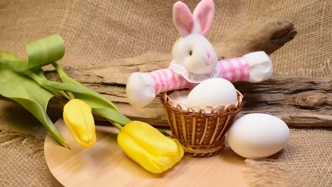 Easter bunny rabbit, eggs in basket and yellow spring tulip flowers Stock Footage 150113089