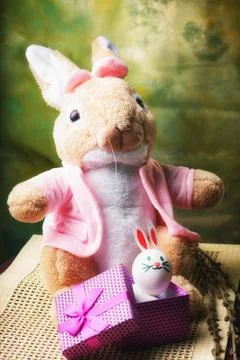 The Easter bunny is sitting on the table. Soft toy. Easter holiday attributes Stock Photos