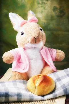 The Easter bunny is sitting on the table. Soft toy. Easter holiday attributes Stock Photos