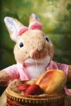 The Easter bunny is sitting on the table. Soft toy. Easter holiday attributes Stock Photos