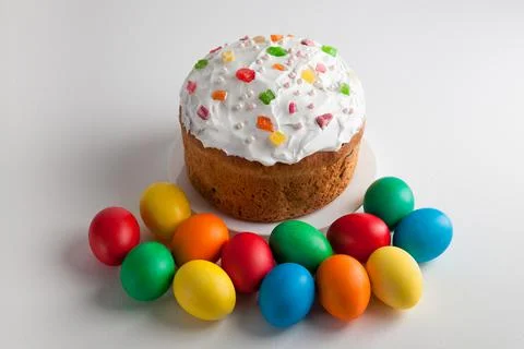 Easter cake and colorful Easter eggs on a white background. Stock Photos