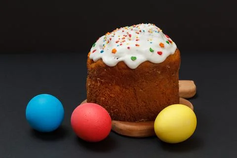 Easter cake and colorful Easter eggs in black background. Stock Photos