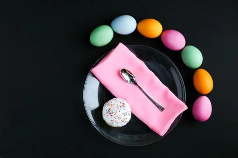 The Easter cake and colourful eggs on a black table Stock Photos