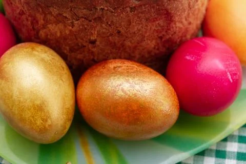 Easter cake and Easter bright colored eggs are on the plate Stock Photos