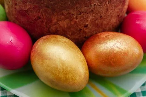 Easter cake and Easter bright colored eggs are on the plate Stock Photos