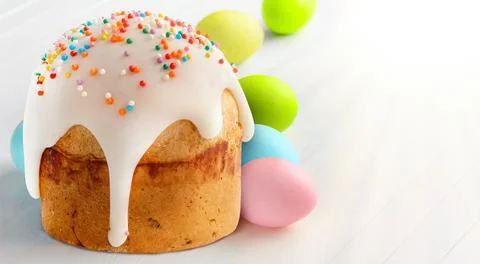 Easter cake and Easter eggs on white wooden table. 写真素材