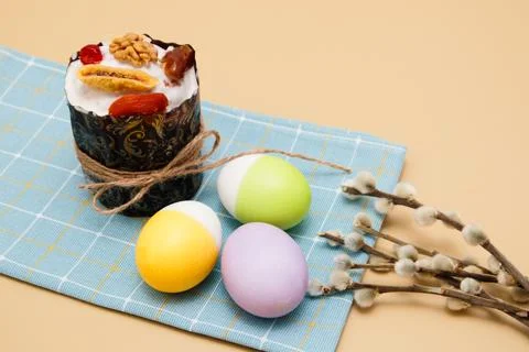Easter cake and Easter eggs with pussy willow branches lie on a blue napkin  Stock Photos