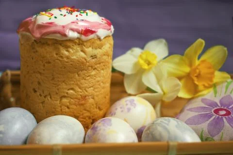 Easter cake and eggs with daffodilson blue background Stock Photos