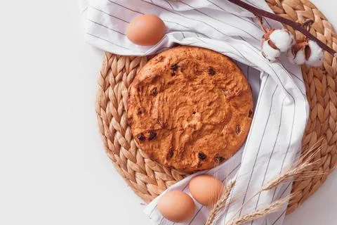Easter cake and eggs on wicker cloth. Top view copy space. Isolated on white. Stock Photos