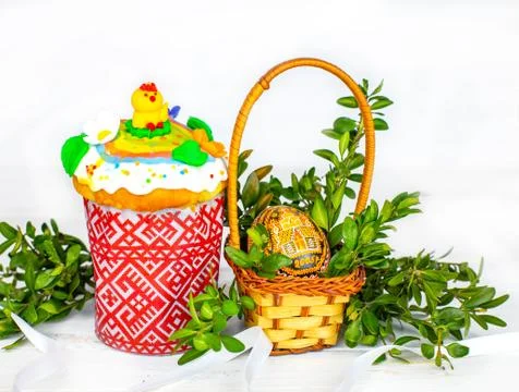 Easter cake and painted eggs, white flowers, festive composition in rustic style Stock Photos