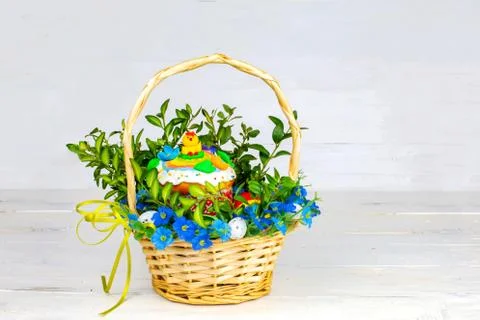 Easter cake and painted eggs, white flowers, festive composition in rustic style Stock Photos