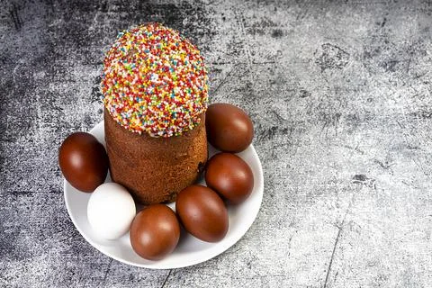 Easter cake and red eggs on a table. Easter background. Stock Photos