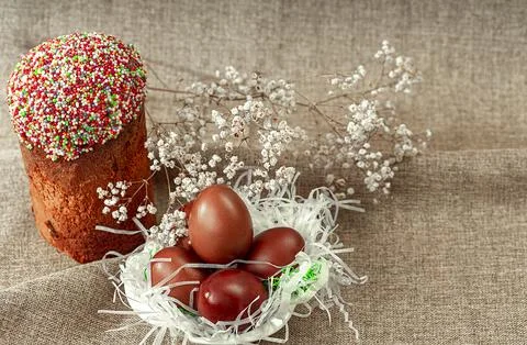 Easter cake and red eggs on a rustic table. Easter background. Stock Photos