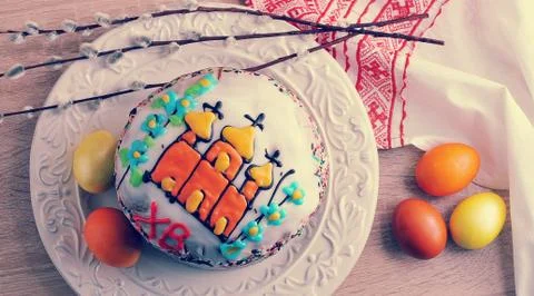 Easter cake with colored eggs and willow twigs Stock Photos
