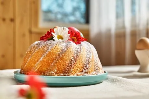 Easter cake decorated with icing sugar, small colorful chocolate eggs and d.. Stock Photos
