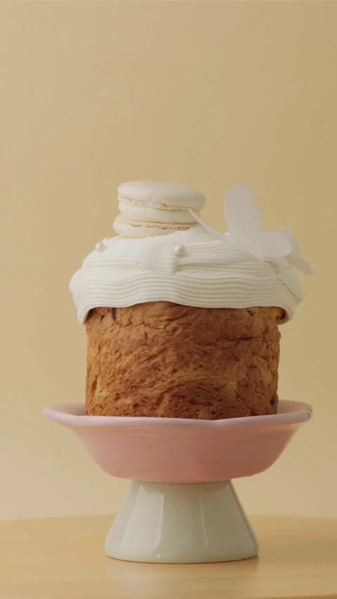 Easter cake decorated with white icing and macaroons Stock Footage 306918942