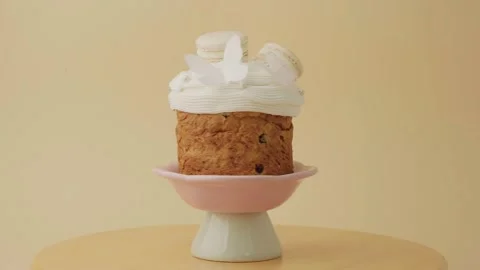 Easter cake decorated with white icing and macaroons Stock Footage 306919020