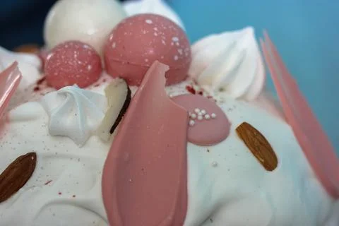 Easter cake decorated with white icing, meringue, pink decorative chocolate ball Stock Photos