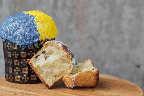 Easter cake is decorated with yellow-blue sprinkles on a gray background. p.. Stock Photos
