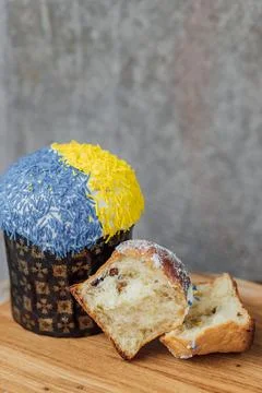 Easter cake is decorated with yellow-blue sprinkles on a gray background. p.. Stock Photos
