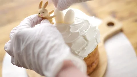 Easter cake decoration.hands of a pastry chef place sugar decorations Stock Footage 300566068
