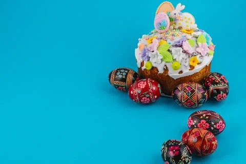 Easter cake with decorative eggs on a blue background Stock Photos