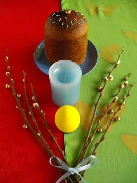 Easter cake with egg, candle and willow branches. Stock Photos