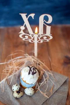 Easter cake, eggs and a candle Stock Photos