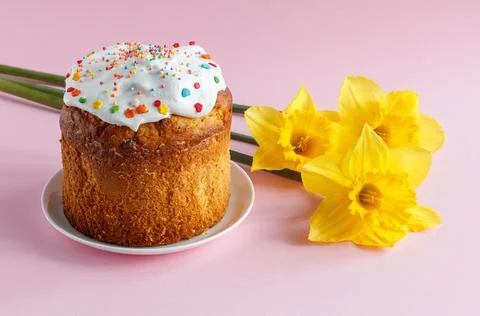 Easter cake, eggs and daffodil flowers on kitchen table. Stock Photos