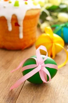 Easter cake, eggs and flowers on the wooden table Stock Photos