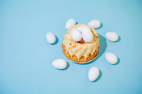 Easter cake with eggs on blue background. Polish babka - traditional Easter Stock Photos