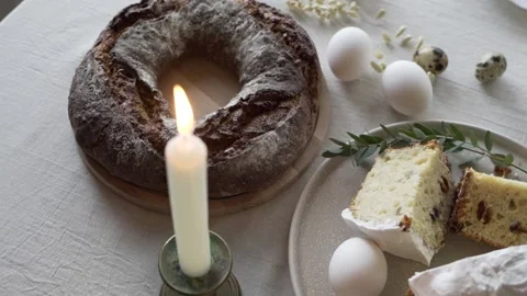 Easter cake, hot bread, eggs and a candle on the table Stock Footage 153800610