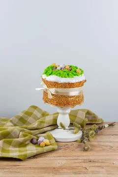 Easter cake made from yeast dough, decorated with edible moss with a nest Stock Photos