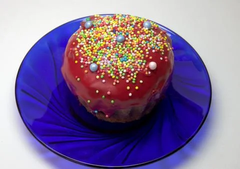 Easter cake, muffin with dark red melted sugar glaze and pastry nonpareil. .. Stock Photos