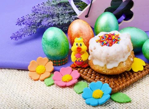 Easter cake, painted Easter eggs and lavender branches on a background of b.. Stock Photos