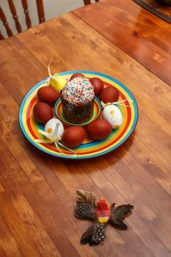 Easter cake with painted eggs on a table made of natural wood. Stock Photos