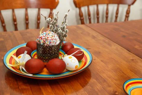 Easter cake with painted eggs on a table made of natural wood. Stock Photos