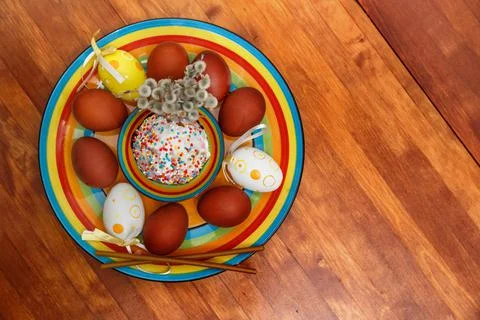 Easter cake with painted eggs on a table made of natural wood. Stock Photos