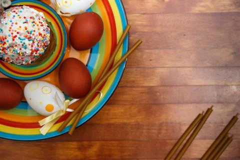 Easter cake with painted eggs on a table made of natural wood. Stock Photos