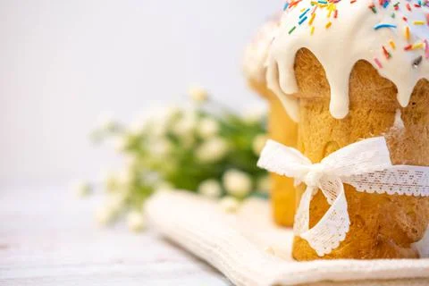 Easter cake, with a porcelain rabbit in the background, on a white table Stock Photos