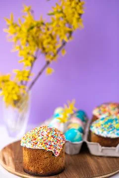 Easter cake on a purple background with yellow spring flowers. easter colored Stock Photos