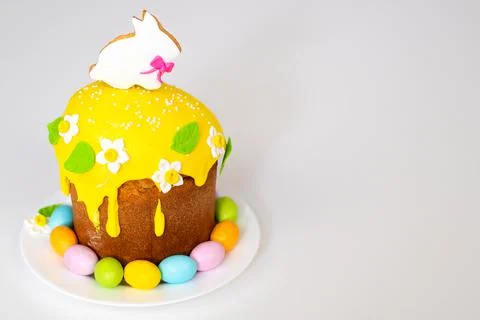 Easter cake with a rabbit and painted eggs on a white background. Religious Stock Photos