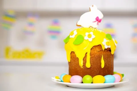 Easter cake with a rabbit and painted eggs on the table. Religious holiday Stock Photos