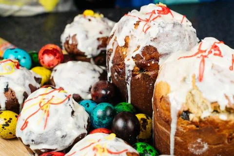 Easter cake on a rustic wooden table with colored Easter eggs. Stock Photos