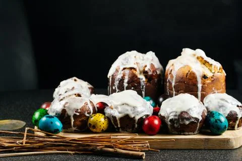 Easter cake on a rustic wooden table with colored Easter eggs. Stock Photos