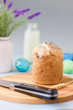 Easter cake standing on easter table, served by easter eggs milk and flowers. Stock Photos
