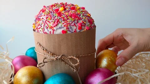 Easter cake surrounded by bright shiny multi-colored Easter eggs Stock Footage 105926199