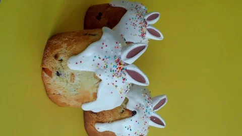 Easter cake three02412032 Vertical Bunny ears Easter cake on yellow Stock Footage 303151343